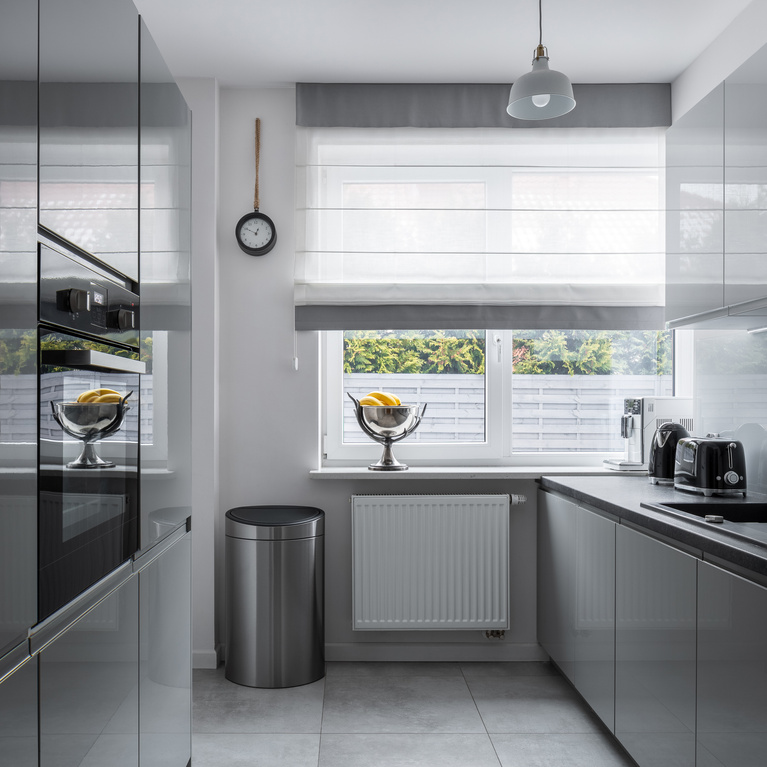Narrow kitchen with gray furniture